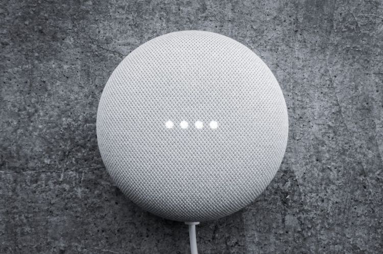 Closeup of a smart speaker sitting on a countertop.