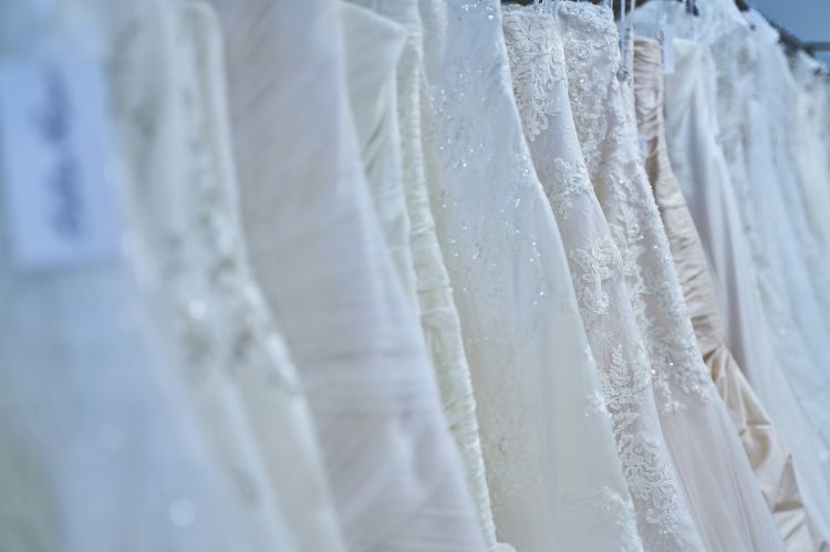a rack of wedding dresses