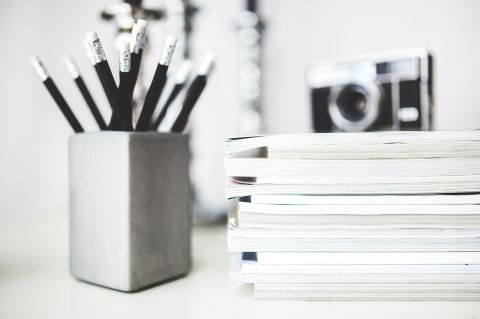 Image by Karolina Grabowska from Pixabay A bunch of pencil next to a stack of paper tablets