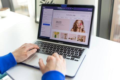 a person using a MacBook Pro to shop on an e-commerce website